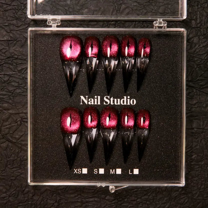 Wine red cat-eye pointed press-on nails, elegant long pointed false nails with a glossy chrome gold finish, creating a seductive, high-end nail design.