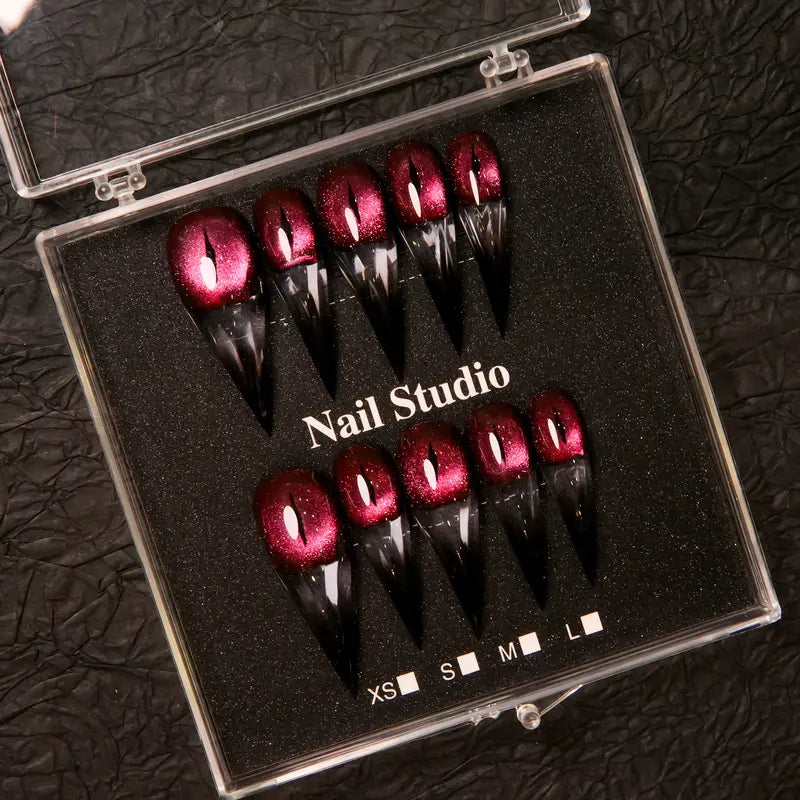 Wine red cat-eye pointed press-on nails, elegant long pointed false nails with a glossy chrome gold finish, creating a seductive, high-end nail design.