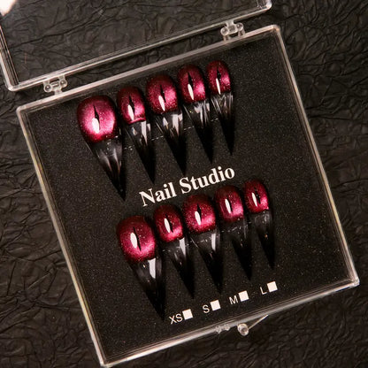 Wine red cat-eye pointed press-on nails, elegant long pointed false nails with a glossy chrome gold finish, creating a seductive, high-end nail design.