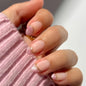 Fall Short Press On Nails Almond, Nude Fake Nails accented with golden glitter and Graceful White Floral Petal Design, Glossy Gel Finish Acrylic Nails, Natural Reusable Glue On Nails for Women