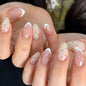 Fall Short Press On Nails Almond, Nude Fake Nails accented with golden glitter and Graceful White Floral Petal Design, Glossy Gel Finish Acrylic Nails, Natural Reusable Glue On Nails for Women