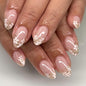 Fall Short Press On Nails Almond, Nude Fake Nails accented with golden glitter and Graceful White Floral Petal Design, Glossy Gel Finish Acrylic Nails, Natural Reusable Glue On Nails for Women